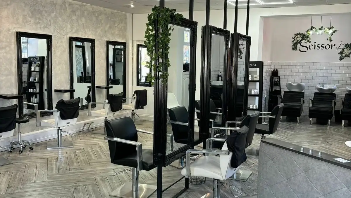 Inside the Scissorz salon: black mirrored styling stations and backwash basins